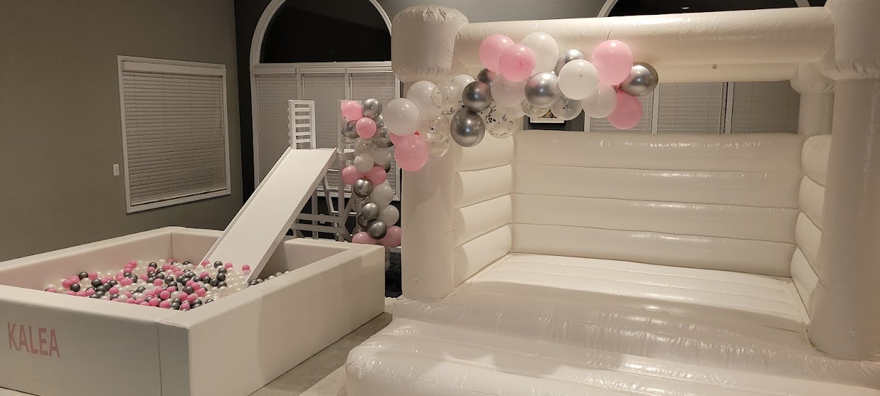 custom pink, white, and silver ball pit, slide, and bounce house